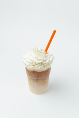 Vertical shot of caramel milkshake with whipped cream and topping on top.