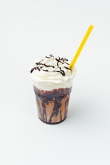 Vertical shot of chocolate milkshake with whipped cream and topping on top.