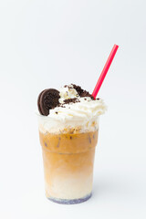 Vertical shot of cookies milkshake with whipped cream and some crumbs on it.