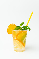 Vertical shot of a fresh orange lemonade in a to go plastic glass with mint.