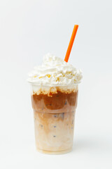 Vertical shot of caramel milkshake with whipped cream and topping on top.