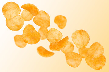 Levitation of potato chips on an orange background.