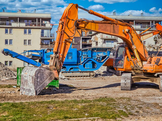 Construction excavator at the demolition site of the house