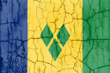 Flag of Saint Vincent and the Grenadines on cracked wall, textured background.