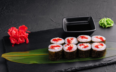 Sushi with red caviar on black stone