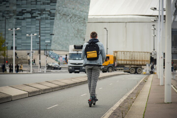 view of a man moving with an electric scooter in Paris