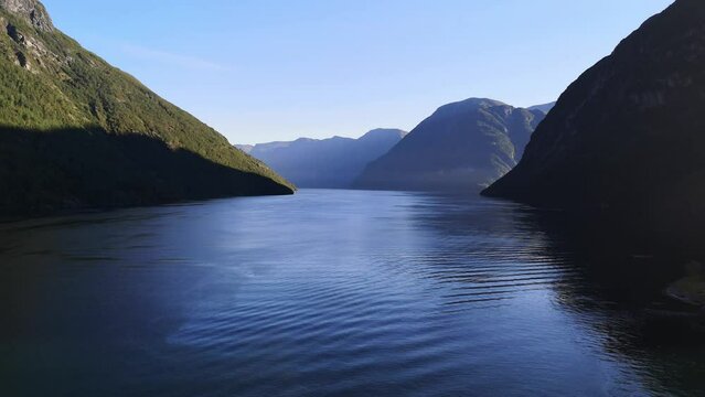 Serene and sunny view of the Norwegian fjords at Hellesylt.