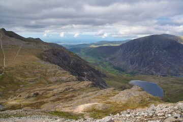 Fototapeta na wymiar Aerial view of the Ogwen Valley in between a mountain range, in Snowdon in Wales, on a cloudy day