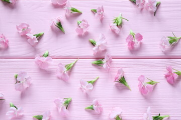 Small pink flowers on wooden table, floral pattern