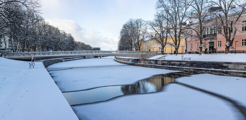 Fototapeta premium Chilling view of a frozen river in the town of Turku in Finland during winter