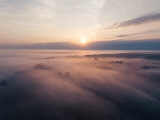 Aerial view of the landscape hardly visible because of the foggy weather at the purple sunset