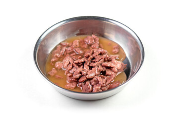 Steel bowl with wet pet feed, food isolated on white, top view.