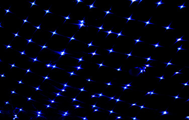 Dark blue lights bokeh on the ceiling of a building in the night. Abstract background for design.
