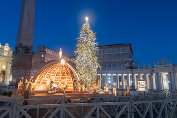 Nativity scene and Christmas tree in Vatican at night.