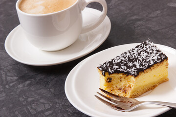 Fresh baked cheesecake and coffee with milk. Delicious dessert