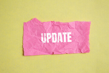 Update word written on wrinkled pink paper piece
