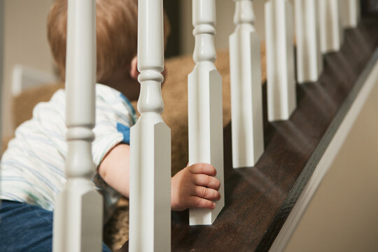 Focus On Hand As Little Boy Climbs Staircase