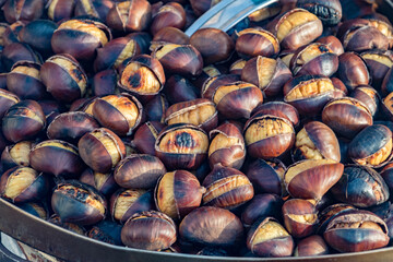 Eat roasted chestnuts. Roasted chestnuts for sale.