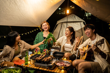 Travel Group of Diverse People Enjoy Camping Tent clinking beer bottles  with Friends, Hang Out Party campsite, Summer Travel and Recreation Concept.