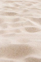 Naklejka na ściany i meble Pink Sand texture natural background. Close up sandy beach sand on shore sea, waves textured dunes, minimal nature vertical fon. Summer and travel, spa and rest concept. Selective focus