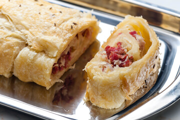 crispy pastry filled with smoked meat and sour cabbage