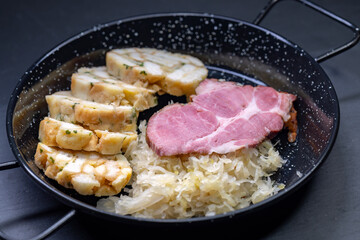 smoked meat served with sauerkraut and dumplings