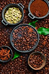 Roasted coffee beans with cardamom and anise. Arabica or robusta coffee. Coffee background.