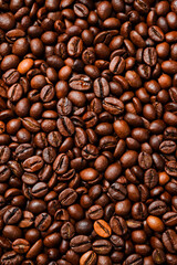 Background of roasted coffee beans. Macro photo. Free space for text. Top view.