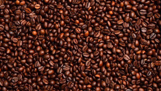 roasted coffee bean background, top view. Macro photo. Free space for text.