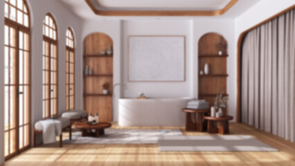Blurred background, bathroom in boho style with arched windows and parquet. Freestanding bathtub, carpet and side tables. Japandi wooden interior design