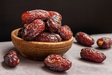close-up Delicious dates in a wooden bowl