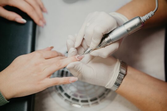 Closeup shot of the nail master removing a shellac from the client's nails