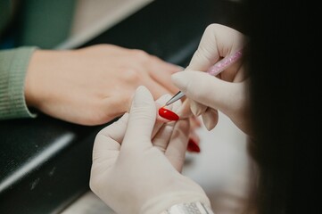 Closeup shot of the nail master working on the client's nails