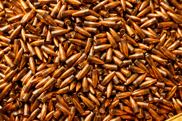Glowing large caliber bullet heap for riffle as background
