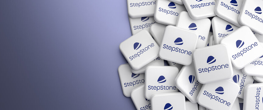 Logos of the employment and career website Stepstone on a heap on a table. Web banner format, copy space.