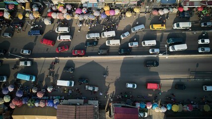 Aerial shot of colorful buses at lorry station in Ghana © Mannuel Narh/Wirestock Creators