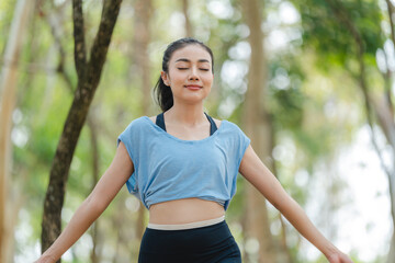 Fitness woman stretching before or after workout, Asian fit girl workout exercise in the morning at nature park outdoor, sport fitness lifestyle for athlete body to wellness healthy