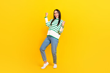Fototapeta na wymiar Full length photo of shiny lucky lady dressed striped pullover screaming rising fists isolated yellow color background