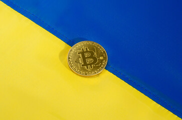 Bitcoin symbol on the background of the Ukrainian flag.