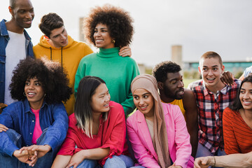 Group of multiracial people enjoy day at city park - Diverse young friedns having fun outdoor