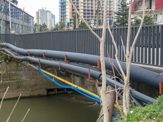 Communications go under the bridge on the river. Wires and pipes under the bridge. Gas pipeline electricity.