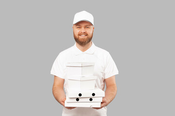 Handsome delivery man wearing white is holding some food delivery boxes.