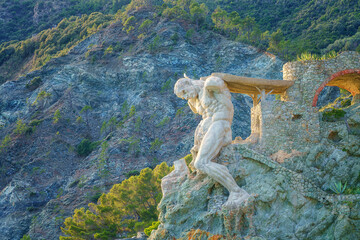 The Giant statue of Monterosso al Mare carved in the rock, symbol of the town, Cinque Terre National Park, Liguria region of Italy. Outdoor travel background