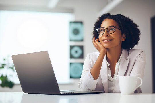 Businesswoman sitting at the desk with excited and inspired expression