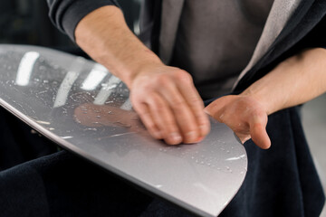 Preparation of a car spoiler for gluing a paint protection film that protects the paint from...