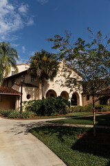 Naklejka premium palm trees near luxurious Mediterranean style house in Miami.