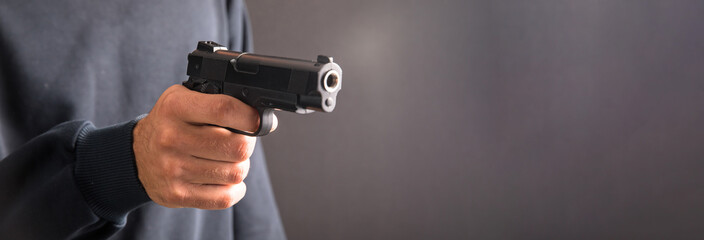 Killer with gun on dark background