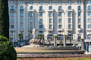 Plaza de Neptuno with its fountain and facade of neoclassical buildings in the city of Madrid, Spain. © josemiguelsangar