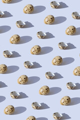 Minimal style pattern made of quail eggs on white background with shadow. Easter creative concept.