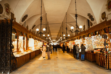 Krakow, Poland - 6th march, 2023: tourist buy souvenirs in famous cloth hall market tourist attraction - Powered by Adobe